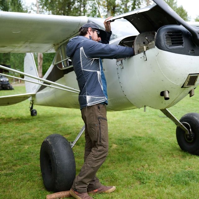 Woman and man wearing Aktivator® Jackets while walking through fall foliage.